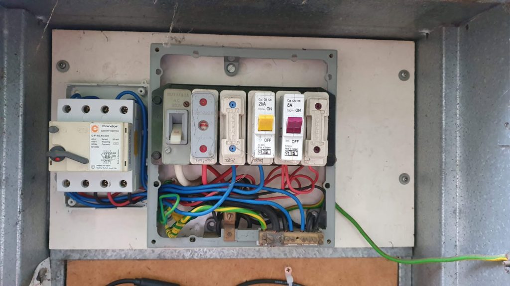 Old outdated switchboard with ceramic fuses before upgrade by Nillumbik Electrical in Melbourne.